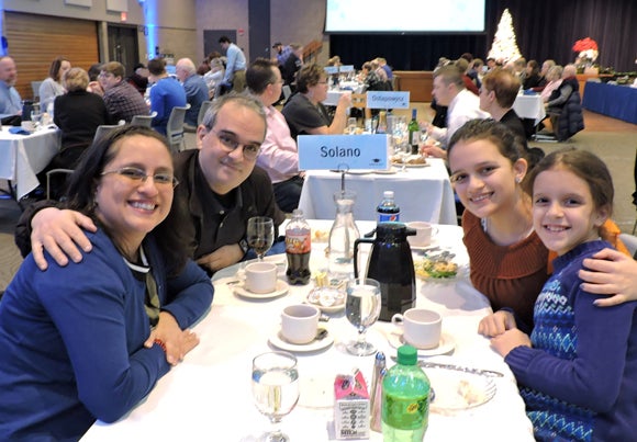 Veronica Solano, along with her husband, Amin Mansuri, and their daughters, Nasim and Anisa, right, attend the graduation buffet. 