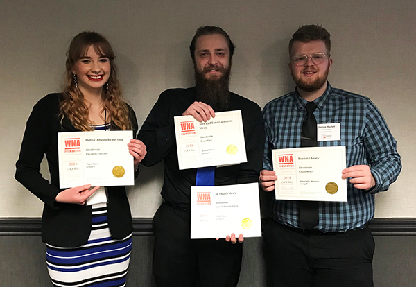From left, Stoutonia staff members Elizabeth Vierkant, Bryce Parr and Logan Myhre celebrate with their Wisconsin Newspaper Association awards.