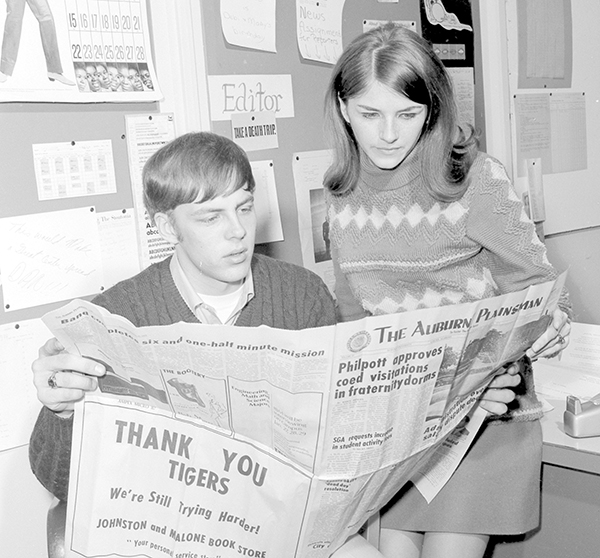 ​​​​​​​Stoutonia student newspaper co-editors Bruce Tietz and Lori Malzahn check a newspaper in 1970.