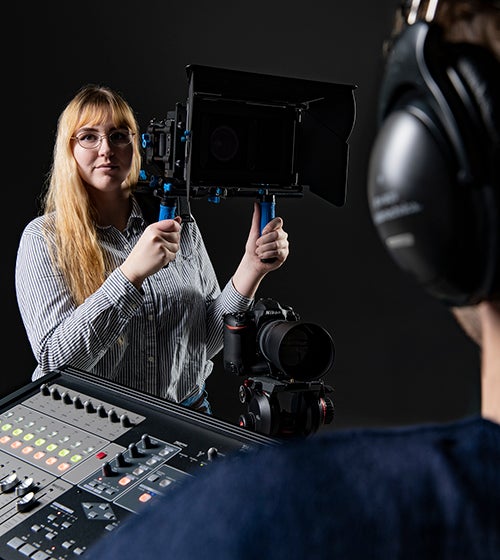 Student Olivia Mayasich helps set up a shot in video lab.