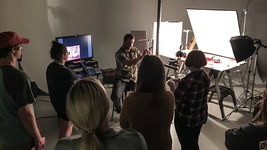 Guest speaker Chris Olson, a food photographer from Minneapolis, works with students.