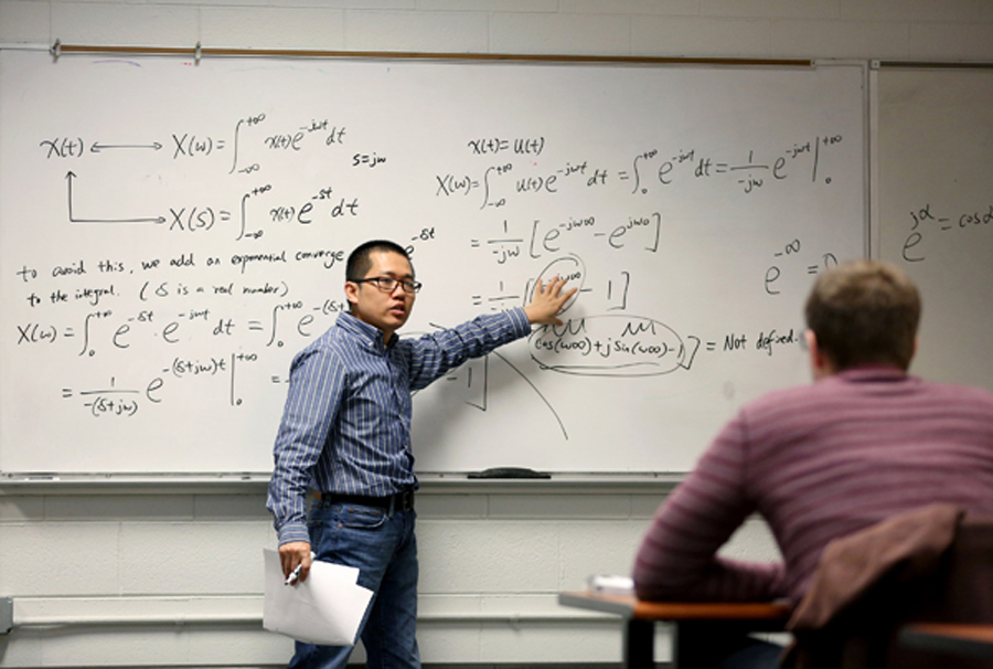Liang Zhan lectures in a classroom.