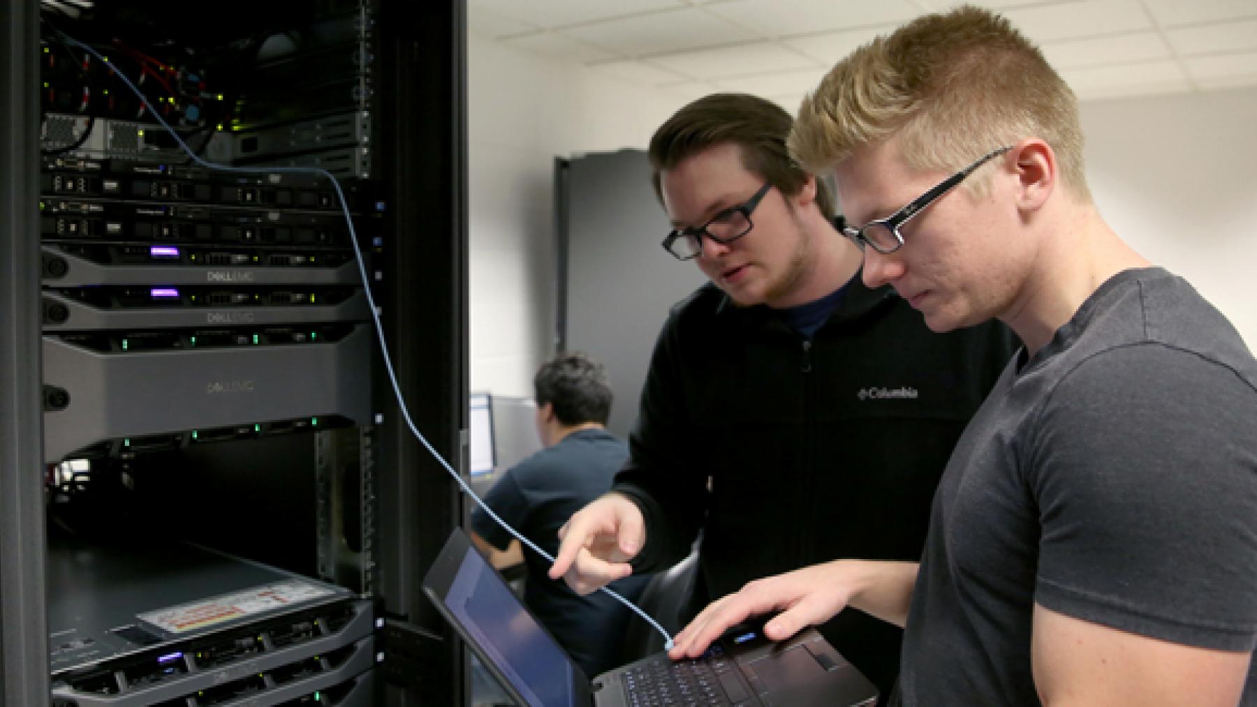 UW-Stout students Pierce Lannue, left, and Stephen Felton work in a computer networking and information technology lab in October in Fryklund Hall. UW-Stout has been named a national Center of Academic Excellence in Cyber Defense.
