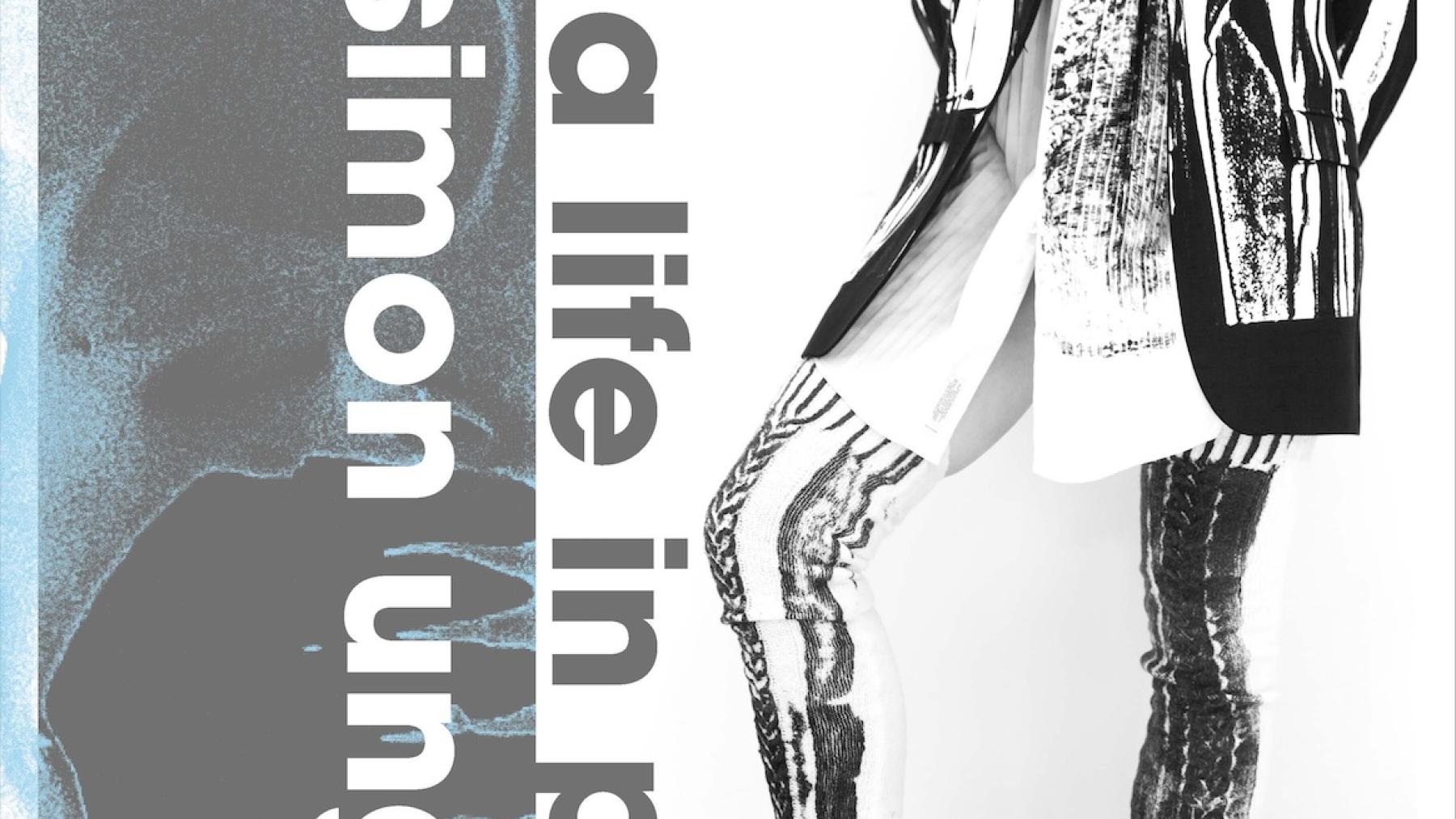 black and white printed fabric is worn by model posing. they wear a jacket, shorts and long socks. the text reads simon unlgess a life in print.