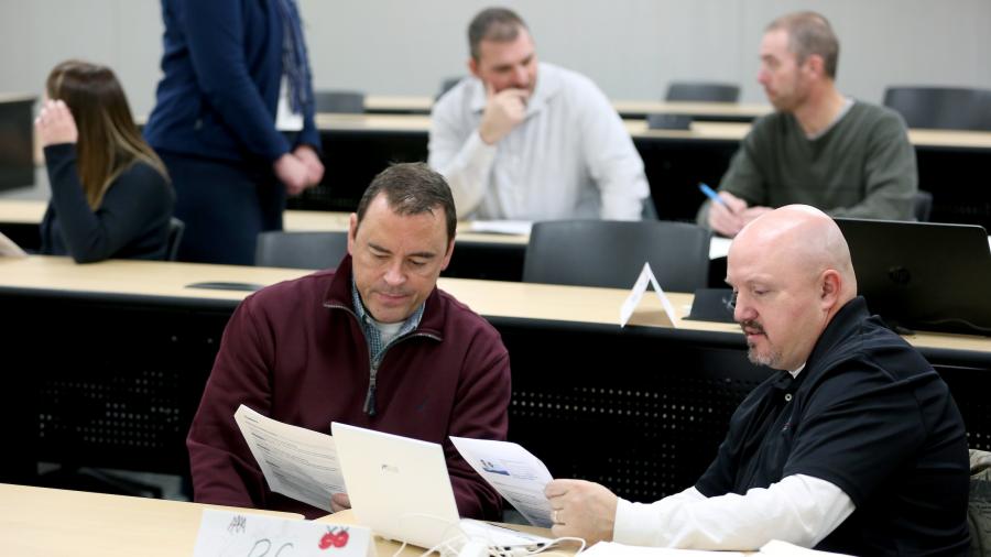 Students John Sobota (left) and R.C. Schroeder discuss topics during their Issues in Career and Technical Education class (CTE-708) in Jarvis Hall Friday, November 10, 2017. (UW-Stout photo by Brett T. Roseman)