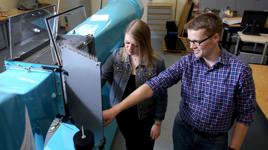 Associate Professor Devin Berg works with student Sarah Dillon in a manufacturing engineering lab in Fryklund Hall.