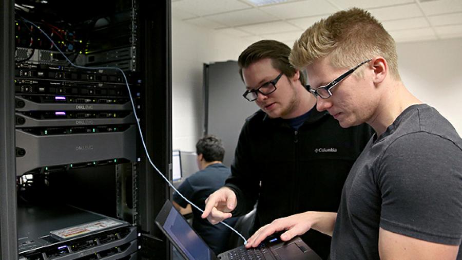 UW-Stout students Pierce Lannue, left, and Stephen Felton work in a computer networking and information technology lab in October in Fryklund Hall. UW-Stout has been named a national Center of Academic Excellence in Cyber Defense.