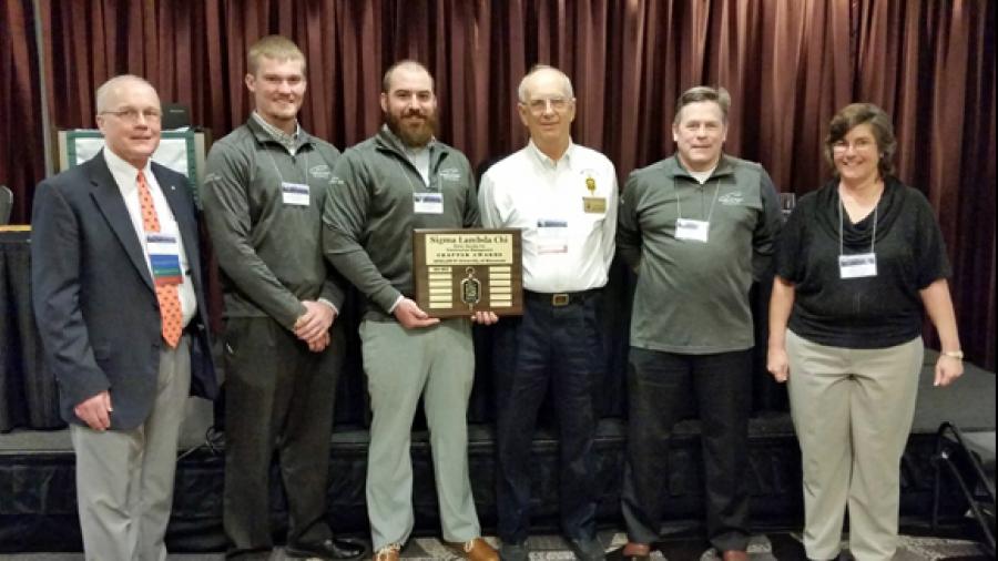 UW-Stout’s Sigma Lambda Chi construction chapter receives the Gold Award for excellence. From left are incoming SLC President Keith Rahn; UW-Stout student Eric Fabich, chapter president; UW-Stout student Cody Witman, chapter vice president; Wes Crawford, Purdue University; UW-Stout Associate Professor Tim Becker and Christine Piper, outgoing SLC president.