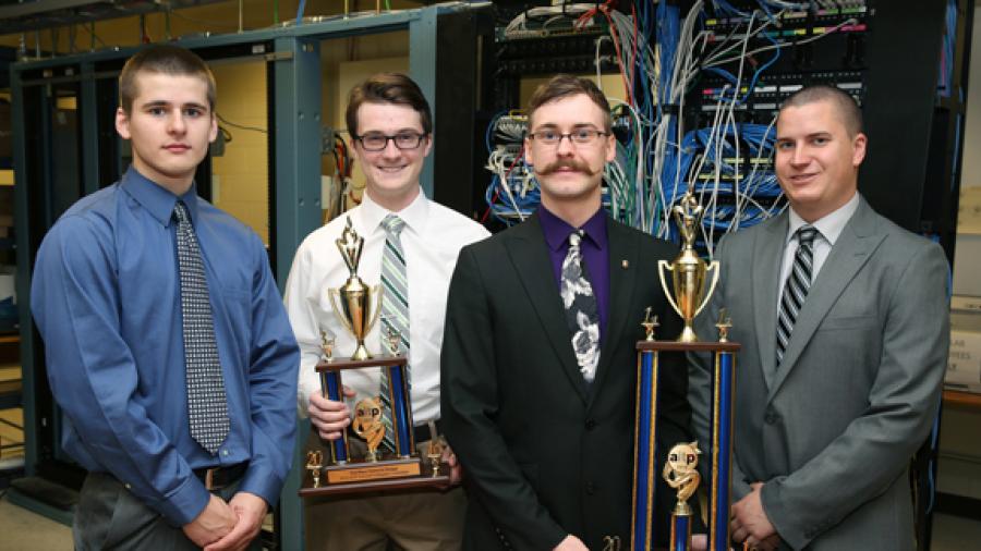 From left, UW-Stout students who placed in a national computer network design contest are Nathanael Satnik and Corey Schoff, third place; and Dan Schmidt and Brandon Wolf, first place. They hold their trophies in a computer networking lab in Fryklund Hall.