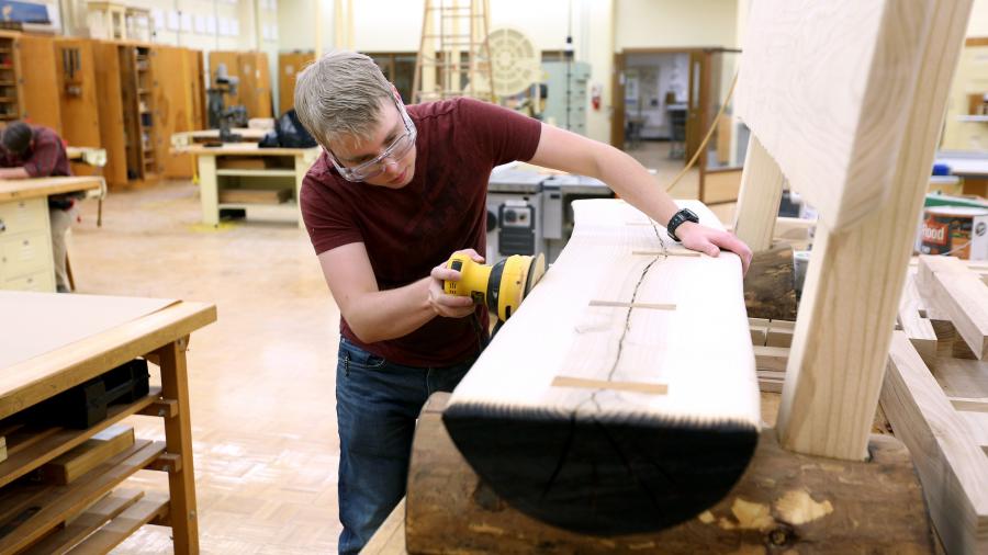 Max Mueller, majoring in engineering technology, works on a bench.