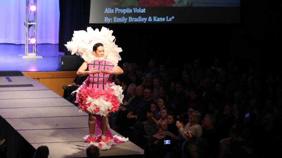 Kane Le modeling his and Emily Bradley's design "Alis Propiis Volat."
