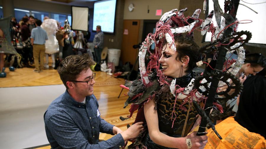 Alice O'Brien and Patrick Brunker putting the final touches on their design "Consuming Bellows" in the MSC Ballrooms before the show.