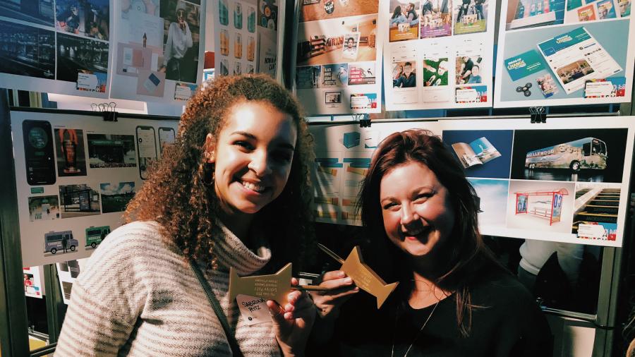 Graphic design students Sabrina Peitz, left, and Rachel Guck show off their gold awards they earned at the AdFed regional advertising competition in Minneapolis.