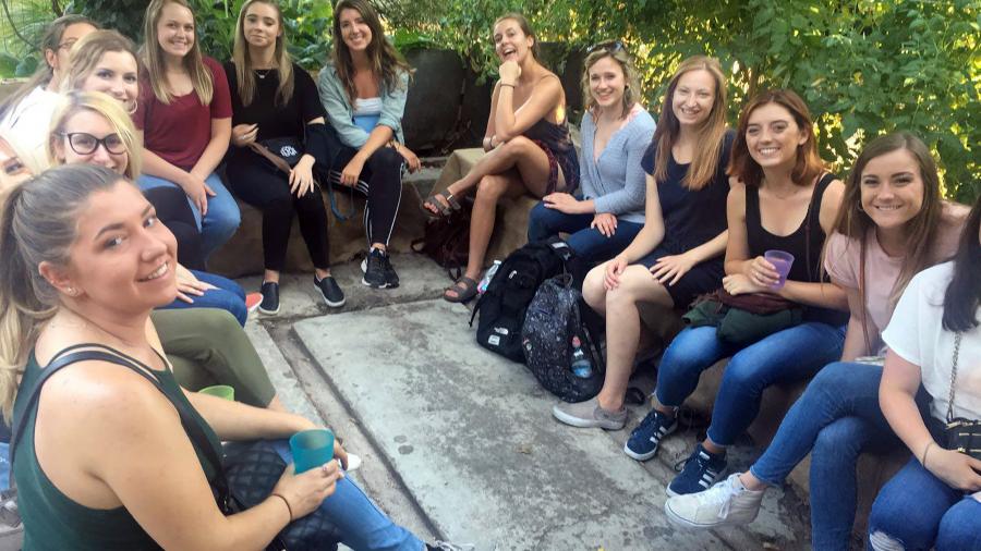 Samantha Bibbs, back left in red shirt, gives a presentation in Florence, Italy, to students about Funghi Espresso.