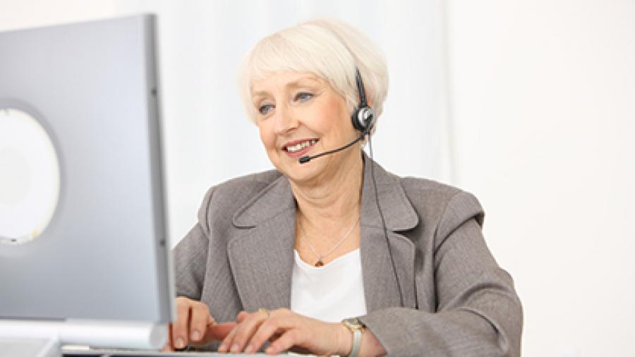 Photo of business woman working on a computer.