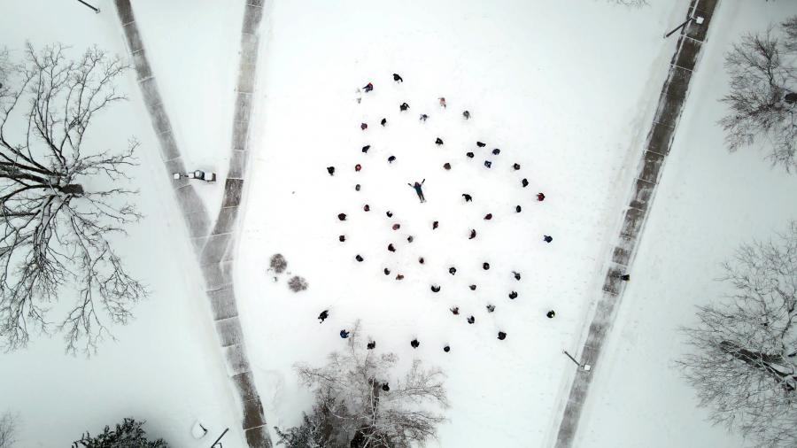 The UW-Stout choir performs in the snow for the Arts Midwest music video “Outro Carnaval” with a Brazilian band led by Paulo Padilha.