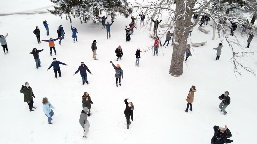 The choir disperses in the snow for the video.