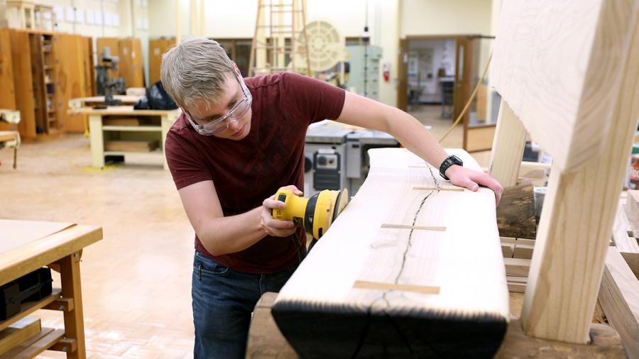 Student Max Mueller works on a bench in 2017 in the wood lab at UW-Stout’s Jarvis Hall Tech Wing.