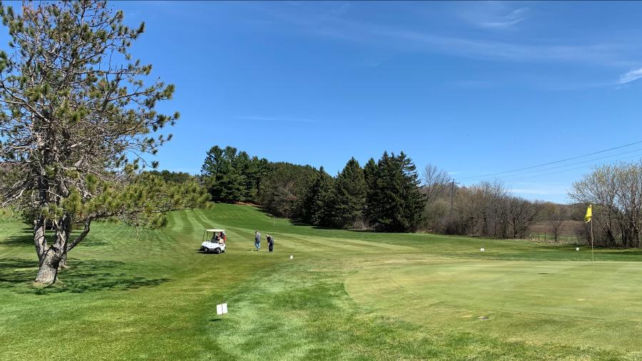 Golfers approach a green at Pine Crest, a nine-hole course in southern Barron County purchased this year by alum Indy Thompson.