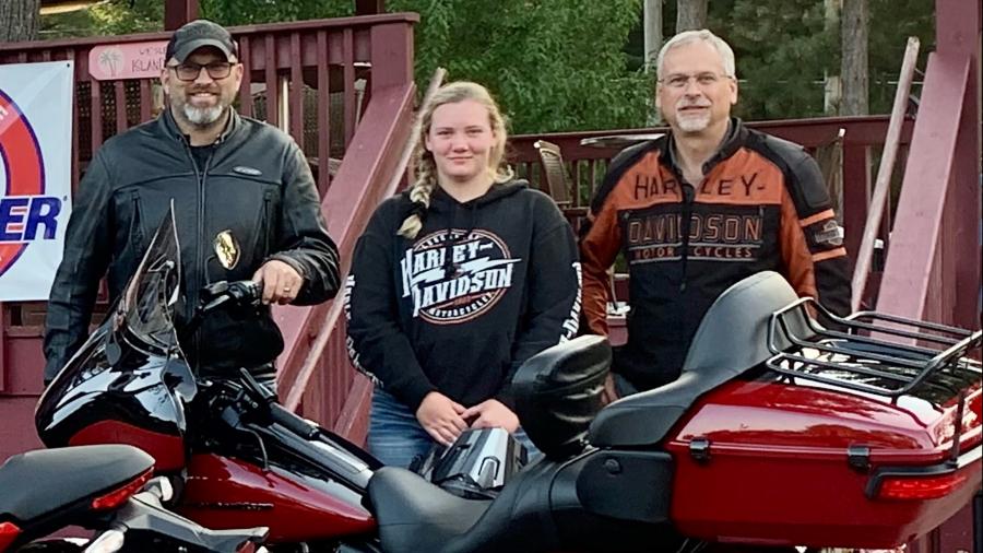 Emily Norgord, a junior this fall at UW-Stout, takes a break from a motorcycle ride with two co-workers from Harley-Davidson, Darin Mrachek, left, and Dennis Deitz. 