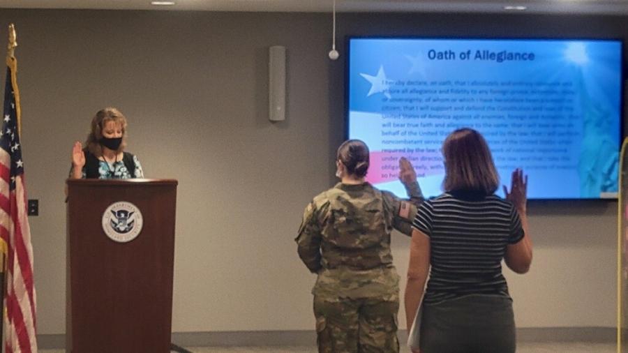 Kayleigh Nel, in center, taking the oath of citizenship in Minneapolis.