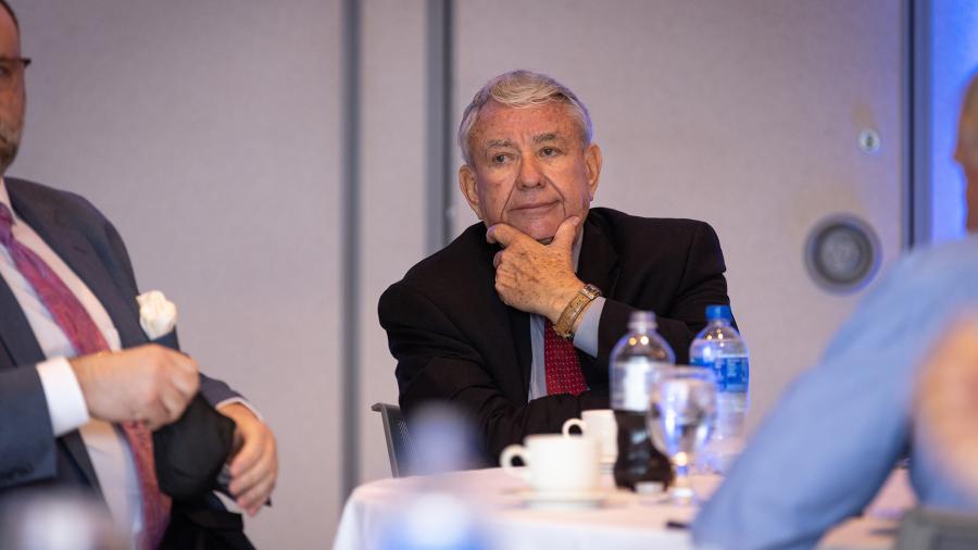 Tommy Thompson listens Monday while meeting during lunch with community officials.