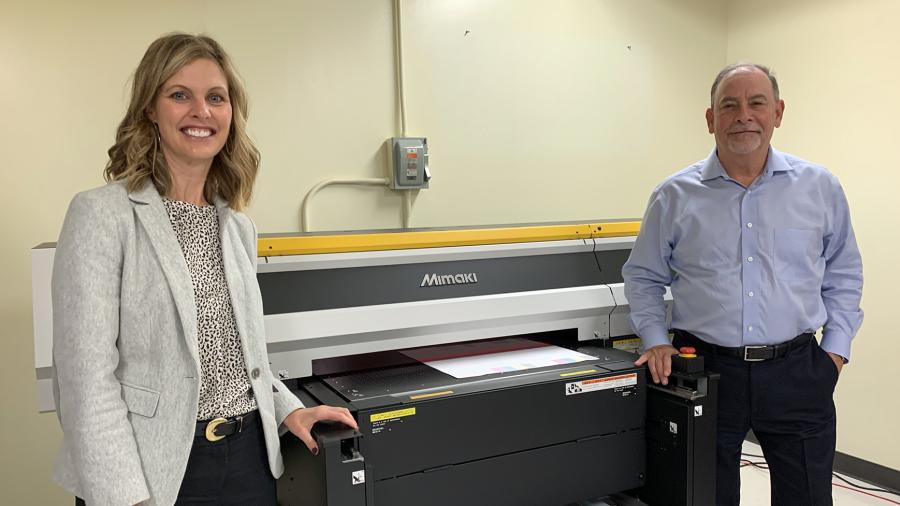 Michelle Hansen, left, and Rick Luftman, vice president of sales and marketing for Green Bay Packaging, viewed the new Mimaki printer that was part of a $180,000 donation to UW-Stout.