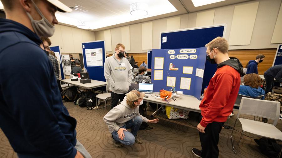 Students demonstrate a fully automatic ice fishing rod and reel during the STEMM Student Expo.