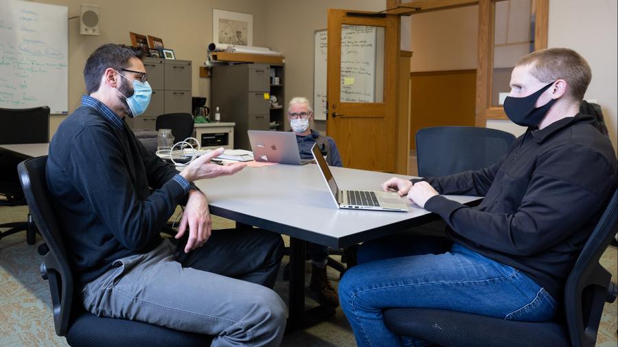 Professor Thomas Pearson, left, was Walker’s adviser on the project, which investigated attitudes toward vaccinations among Dunn County residents.
