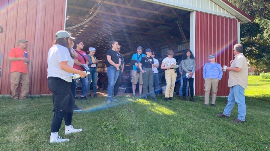 LAKES students on the Prestebak farm speaking with Steve Olson, a conservation planner at Dunn County, about soil health and conservation farming.