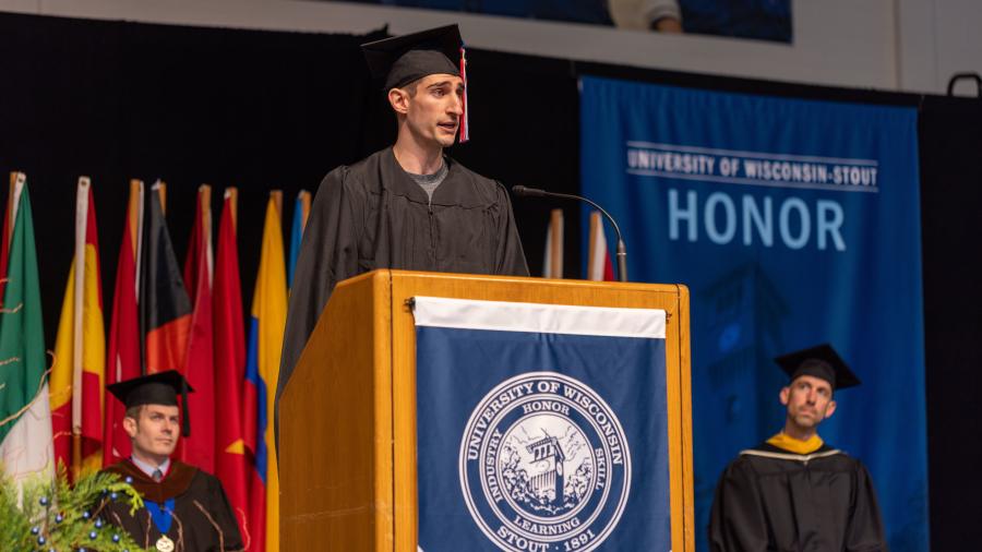 Master’s degree recipient and speaker Corey Tellier addresses fellow graduates during the Graduate School ceremony.