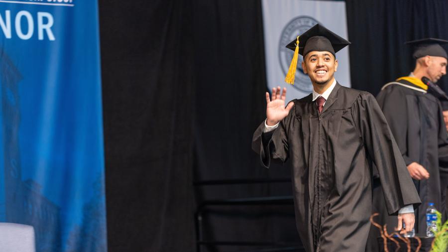Abdulaziz Basharaheel crosses the stage at commencement on Dec. 17.