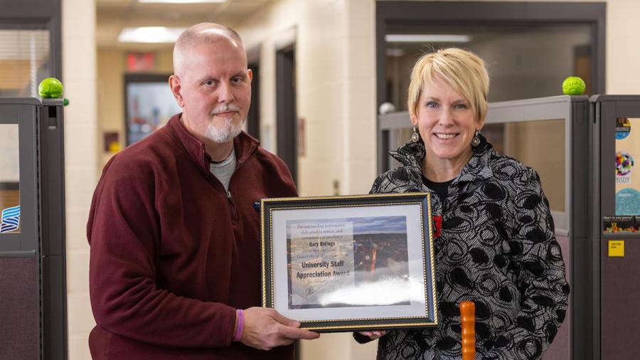 Gary Ridings, left, receives the January University Staff Employee Appreciation award from Chancellor Katherine Frank.