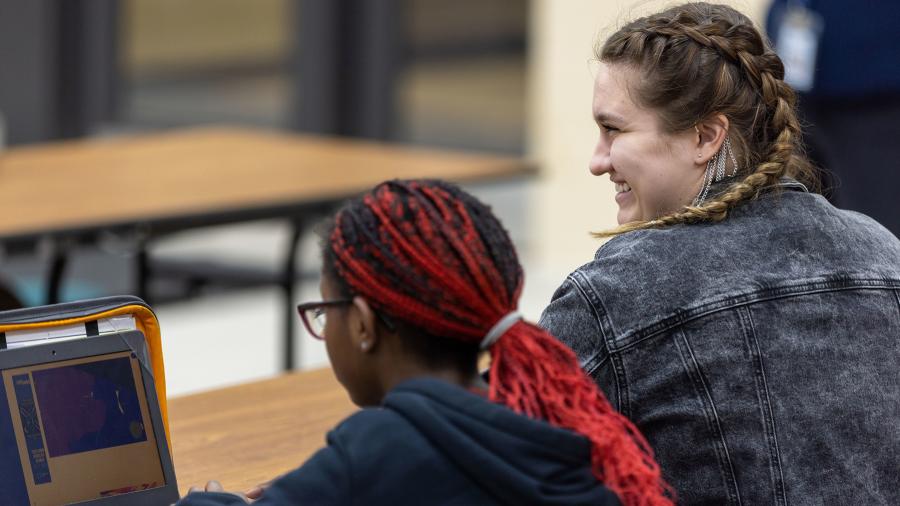 UW-Stout student Jazmine Williams helps a student at the new Boys & Girls Clubs middle school program in Menomonie.