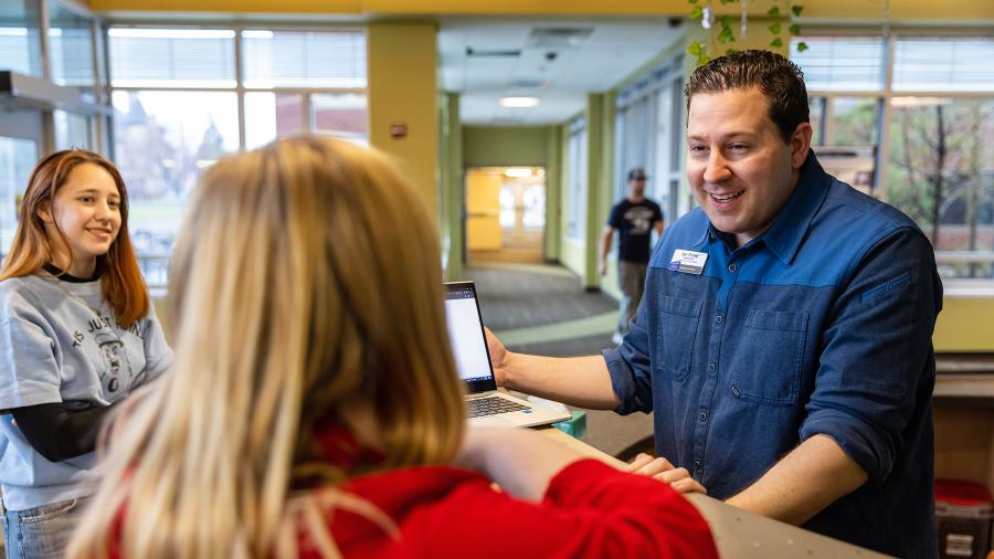 Ian Foley helps students at one of the UW-Stout residence halls.