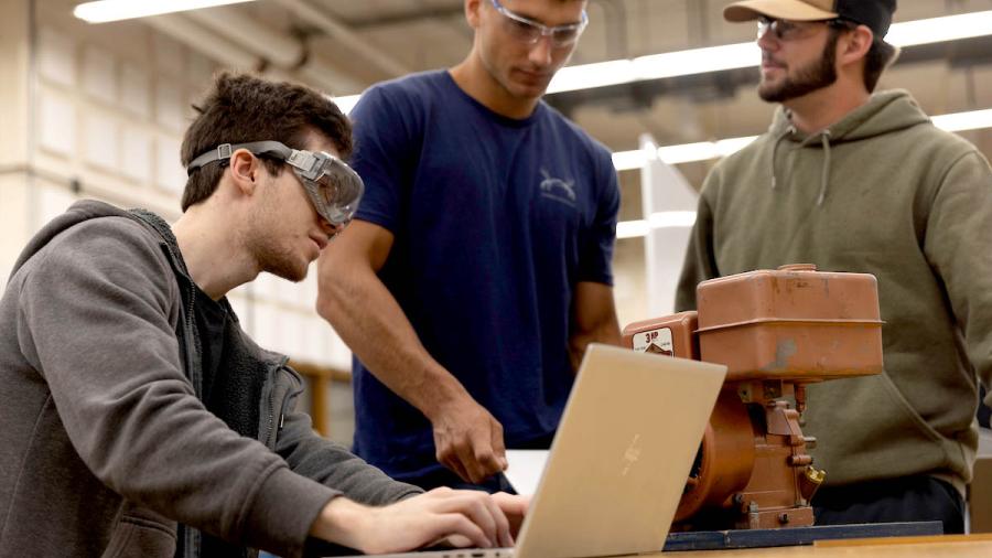 Mechanical engineering students at a worktable