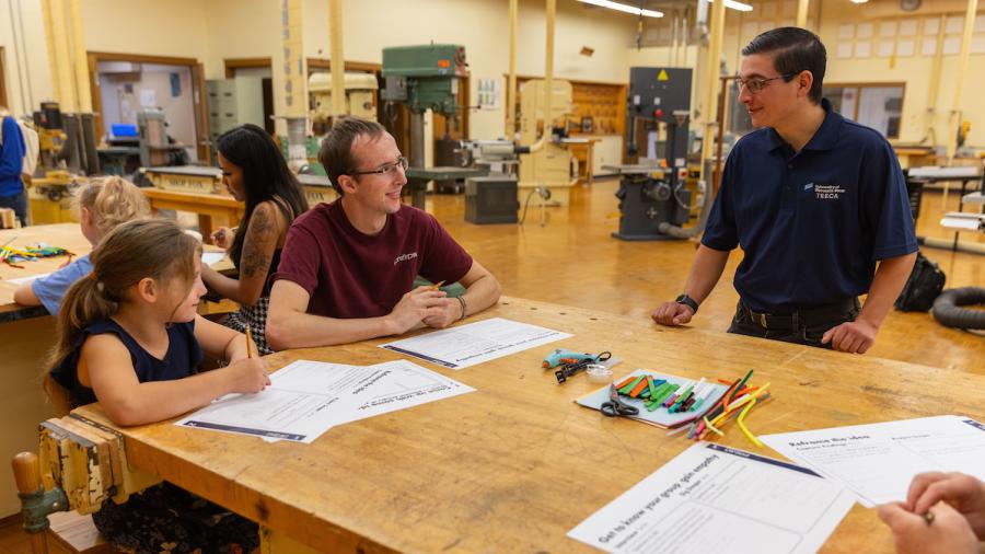 Technology education student Lucas Edson, right, talks with a classmate and first-grader about their toy design.