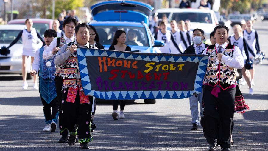 The Hmong Stout Student Organization marches in the 2022 homecoming parade.