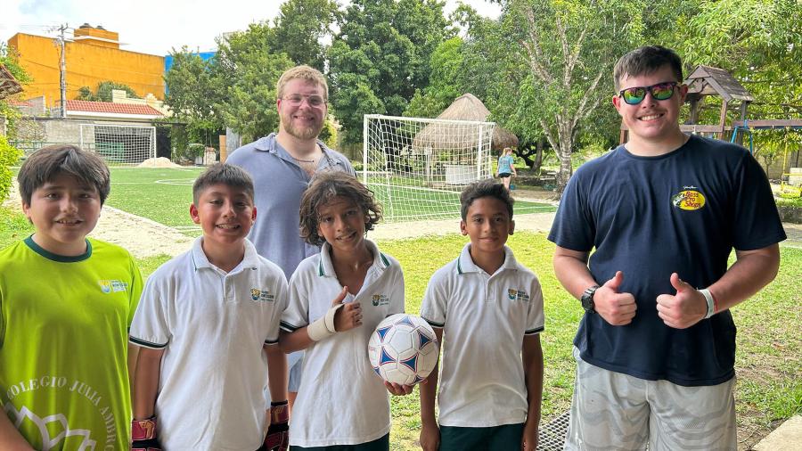 Education in Cozumel students playing soccer with Montessori students