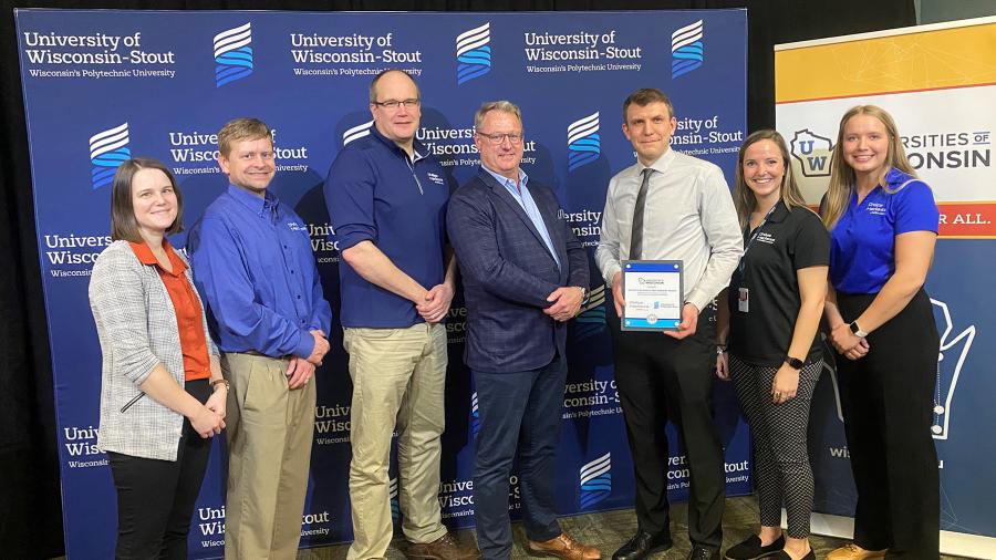 Members of the Phillips-Medisize team take part in the award presentation, including Dave Thoreson, center, and UW-Stout student intern Grace Thoreson, right.
