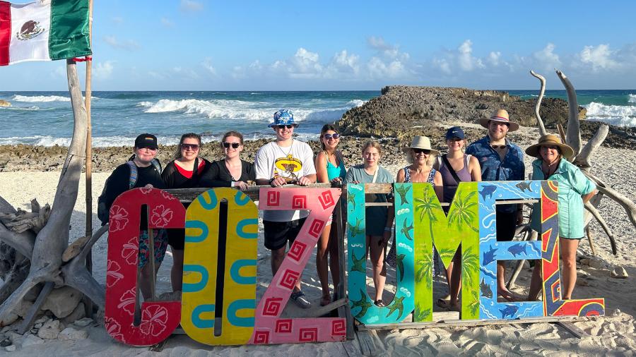 Education in Cozumel students and faculty at the beach