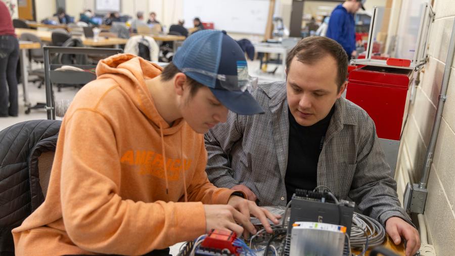 Tanner Hornung, mechanical engineering, and Aaron Philson, computer and electrical engineering, assemble the control board for their robotic go/nogo verification system project.