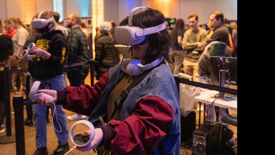 Visitors at the semiannual Stout Game Expo, SGX, use virtual reality goggles to try a student-made game.