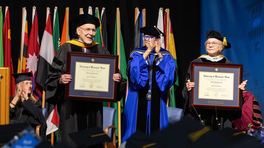 Dallas and Edye Pankowski receive honorary doctorate degrees at commencement May 4 as Chancellor Katherine Frank applauds.