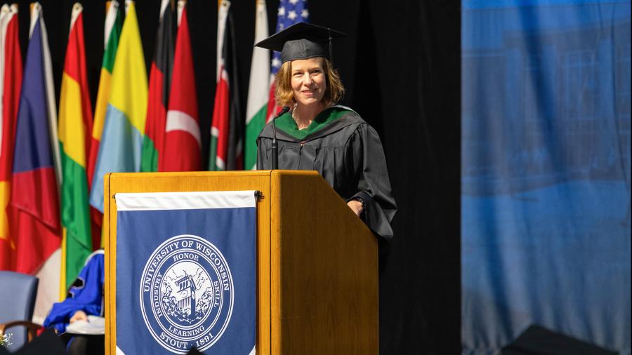 Emily Berge, who has two degrees from UW-Stout and is Eau Claire City Council president, speaks during the Graduate Studies ceremony.