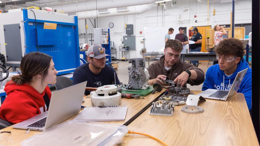 Mechanical engineering students work on an engine project in the renovated Engineering Technology Research and Development Lab.