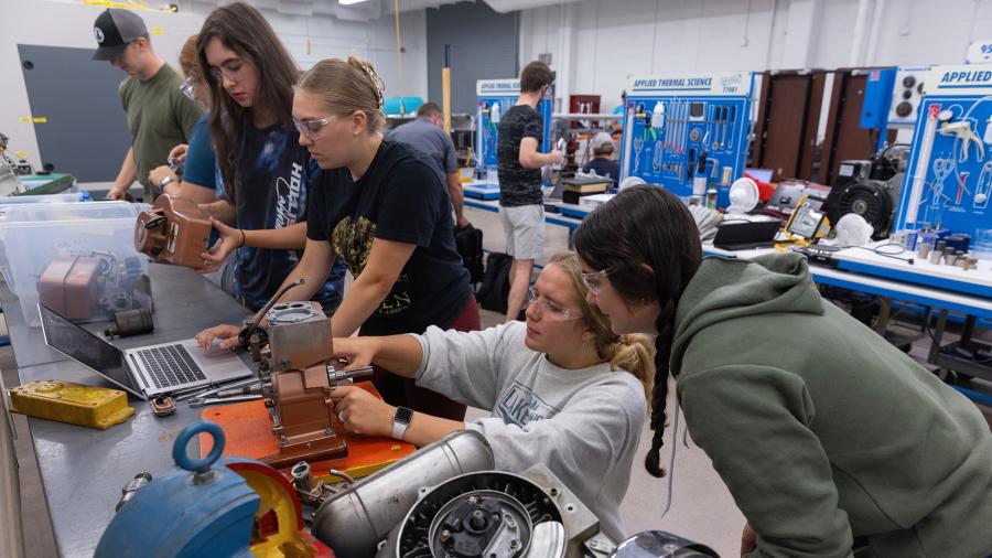 Mechanical engineering students work on an engine project in the renovated Engineering Technology Research and Development Lab.