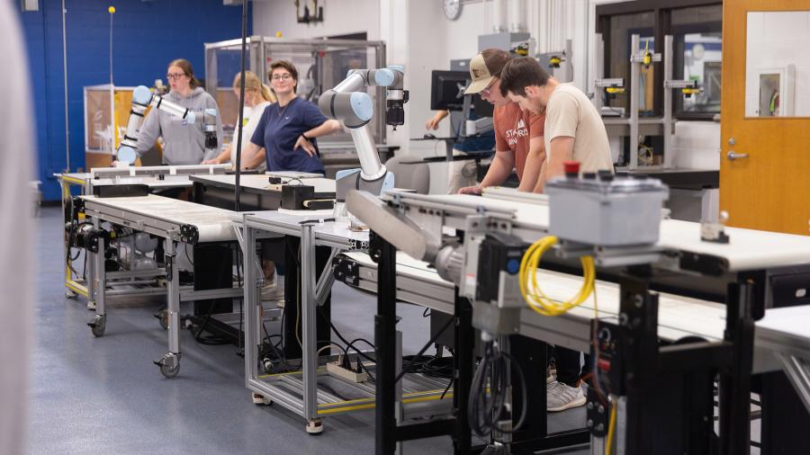 Students and machinery in a robotics lab.