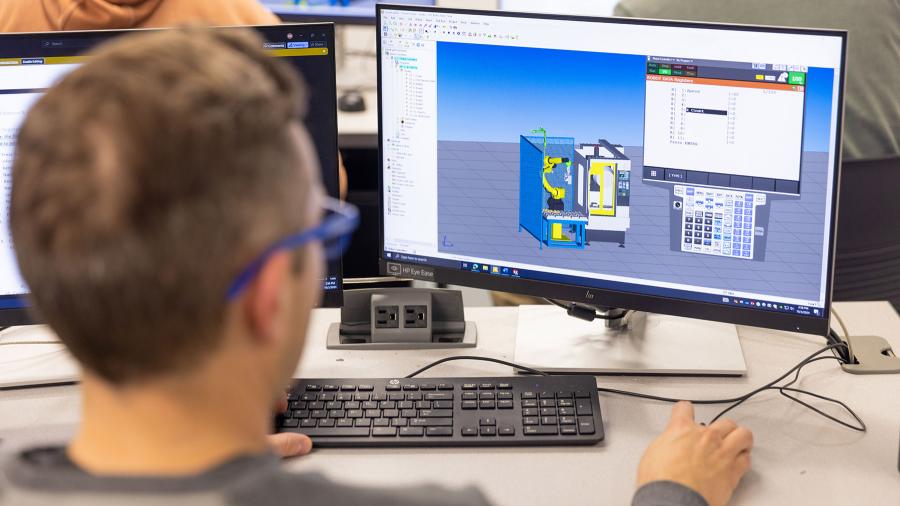 An engineering student looks at a computer screen.