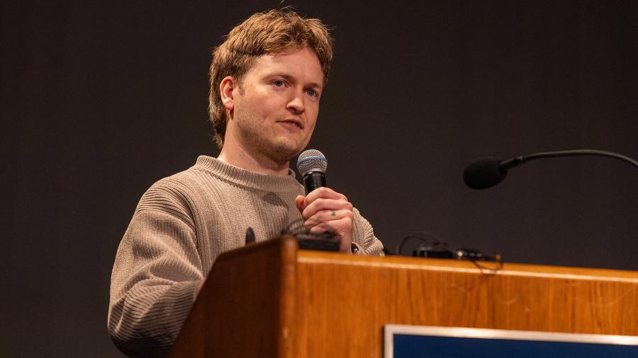 A man speaks at a podium